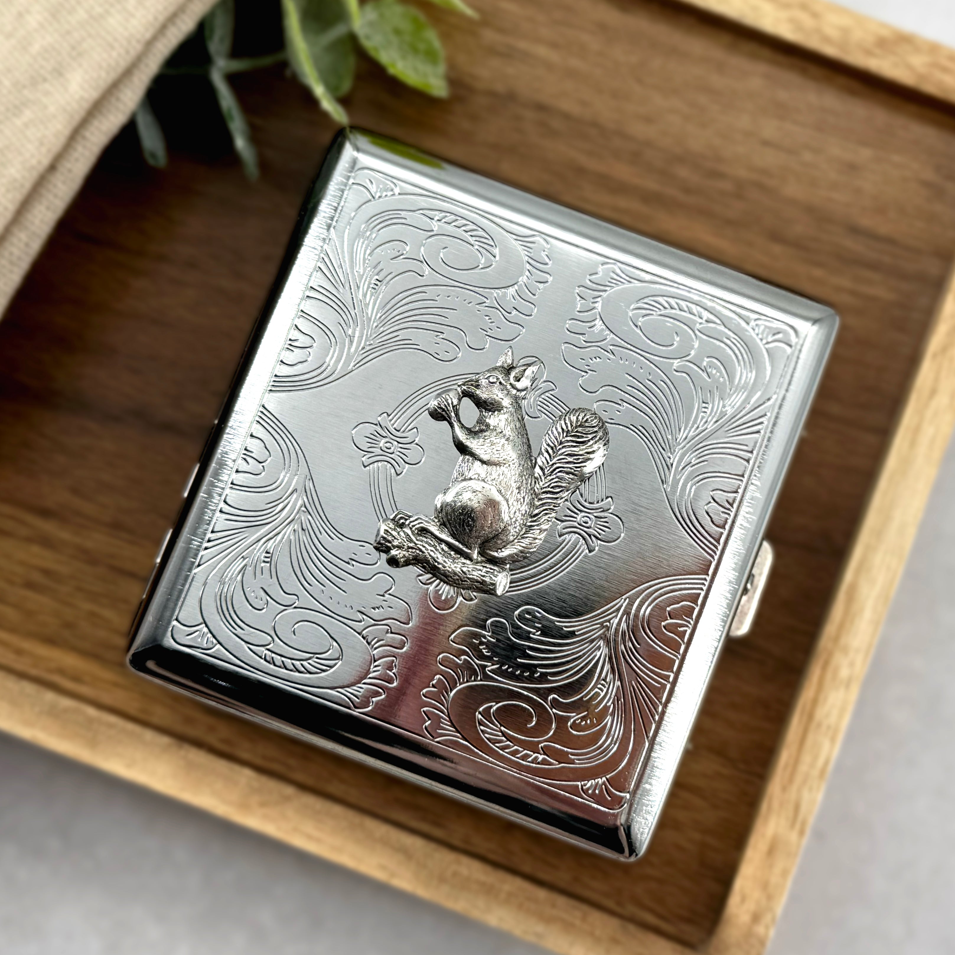 Handmade woodland squirrel case displayed on natural wood surface