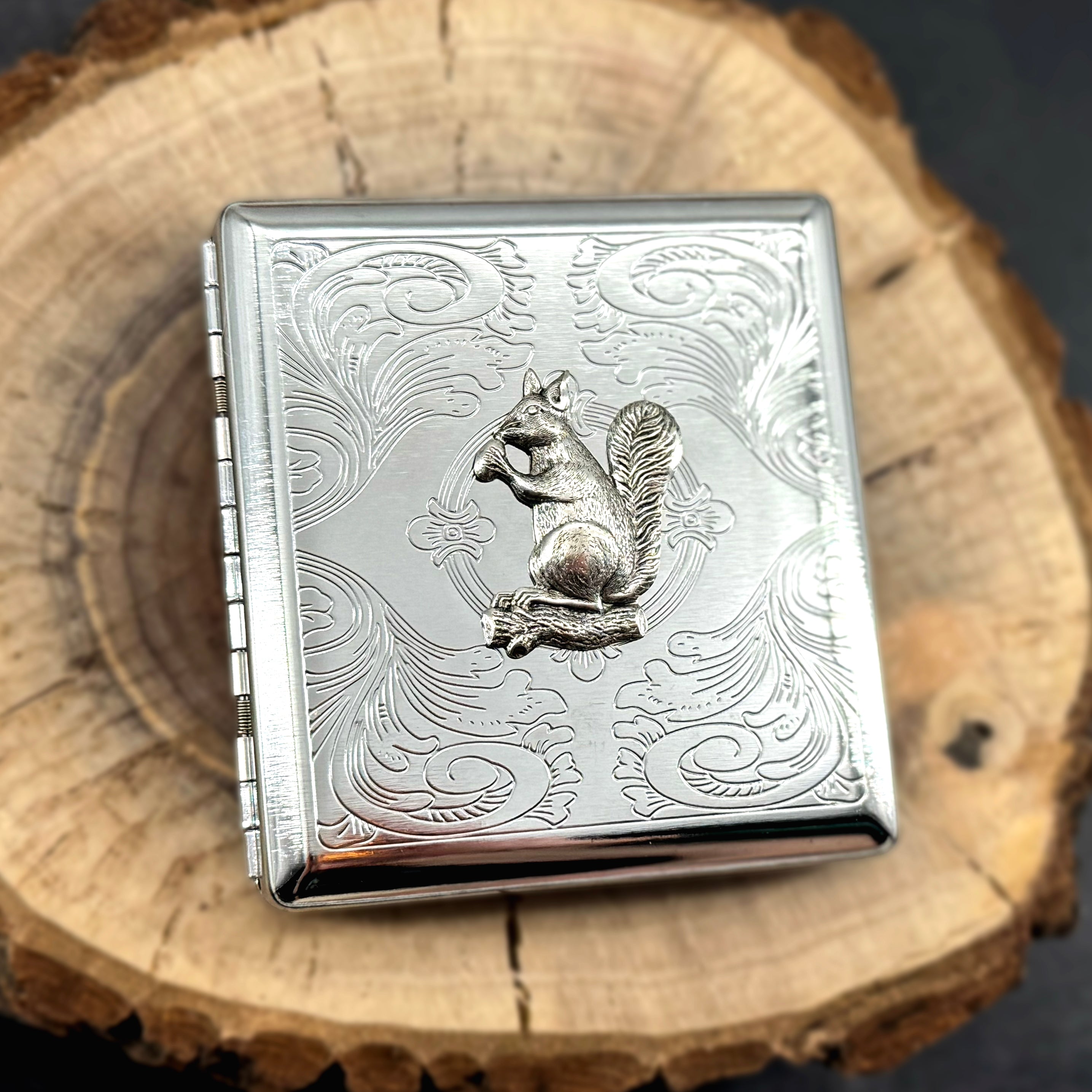 Metal card holder featuring detailed squirrel embellishment