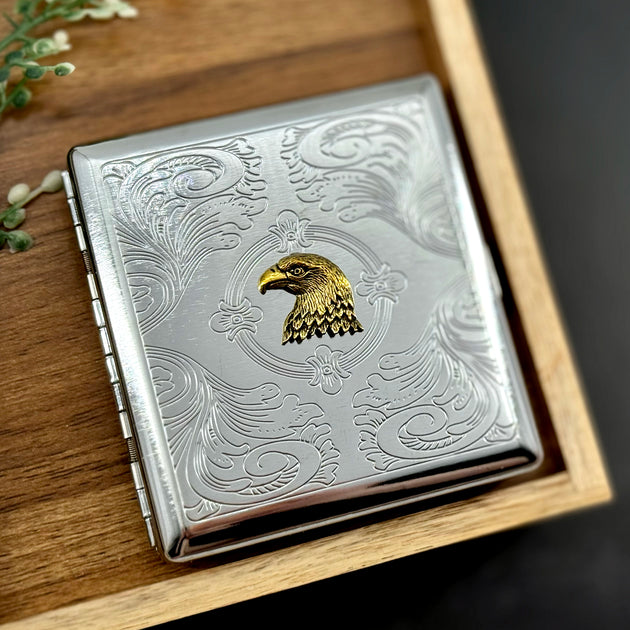 Eagle cigarette case with raised eagle emblem and engraved ornamental background