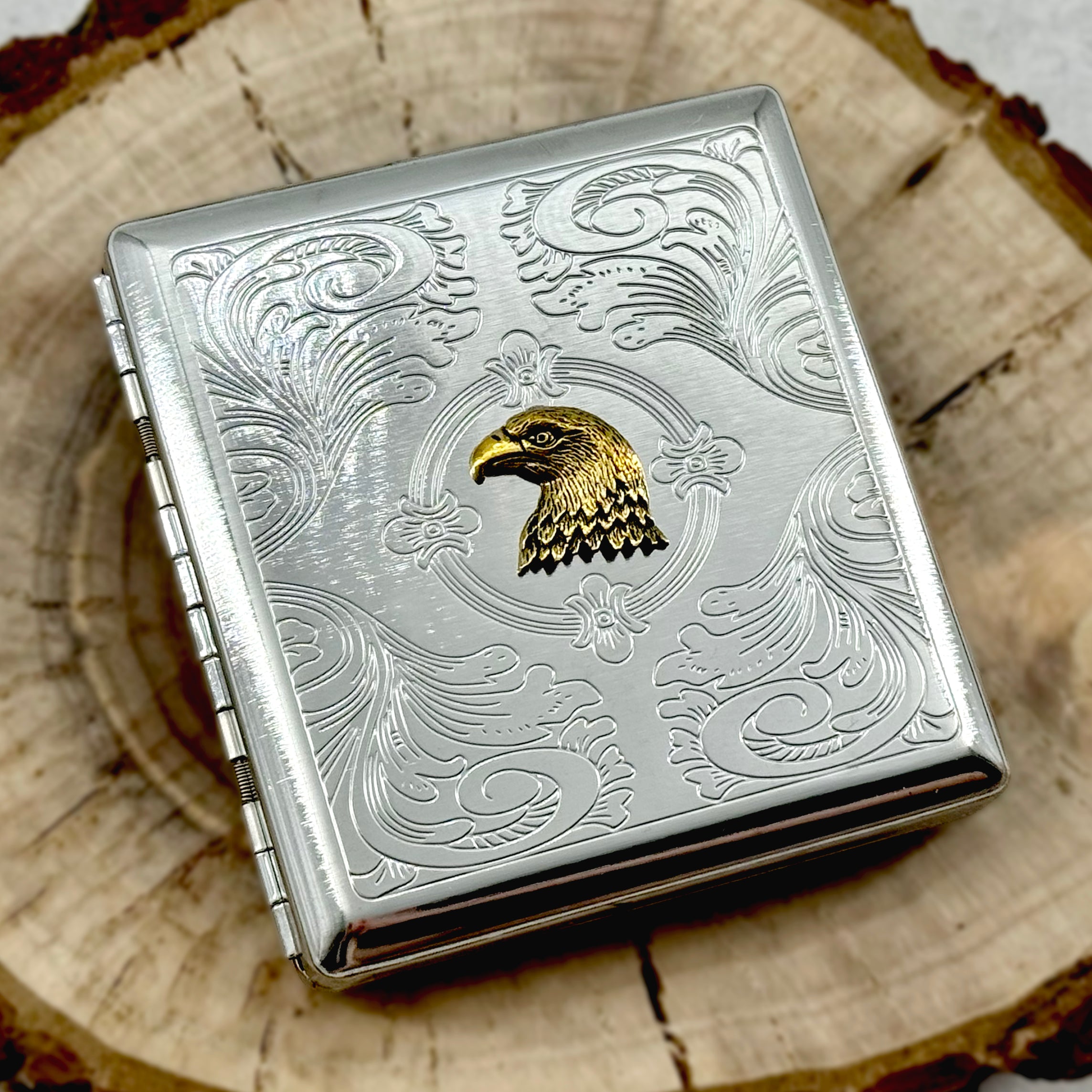 Wildlife-inspired eagle pocket case displayed on a wooden tray