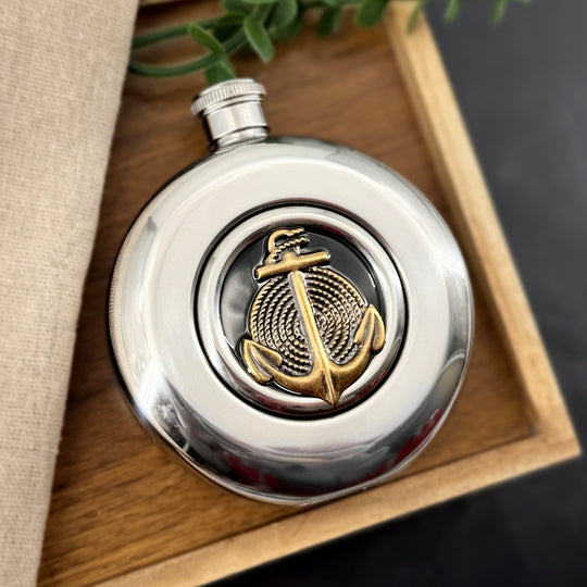 Antique bronze anchor and rope detail inside circular flask window