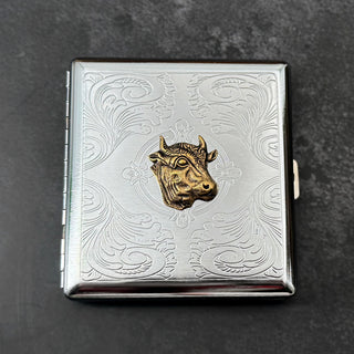 Handmade silver metal cigarette case featuring a raised bronze-toned cow head.