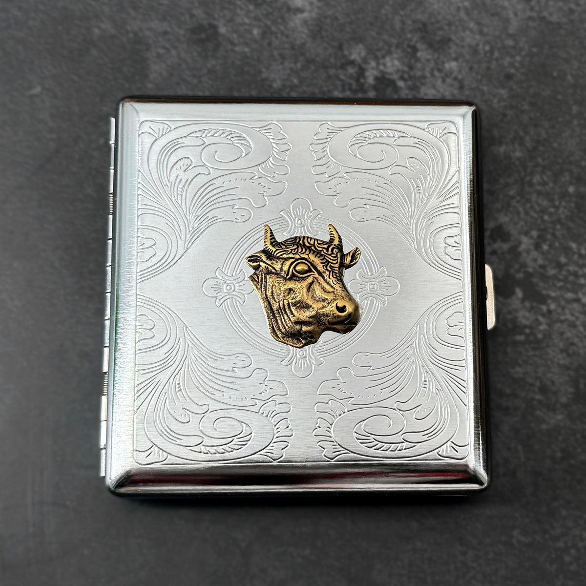 Handmade silver metal cigarette case featuring a raised bronze-toned cow head.
