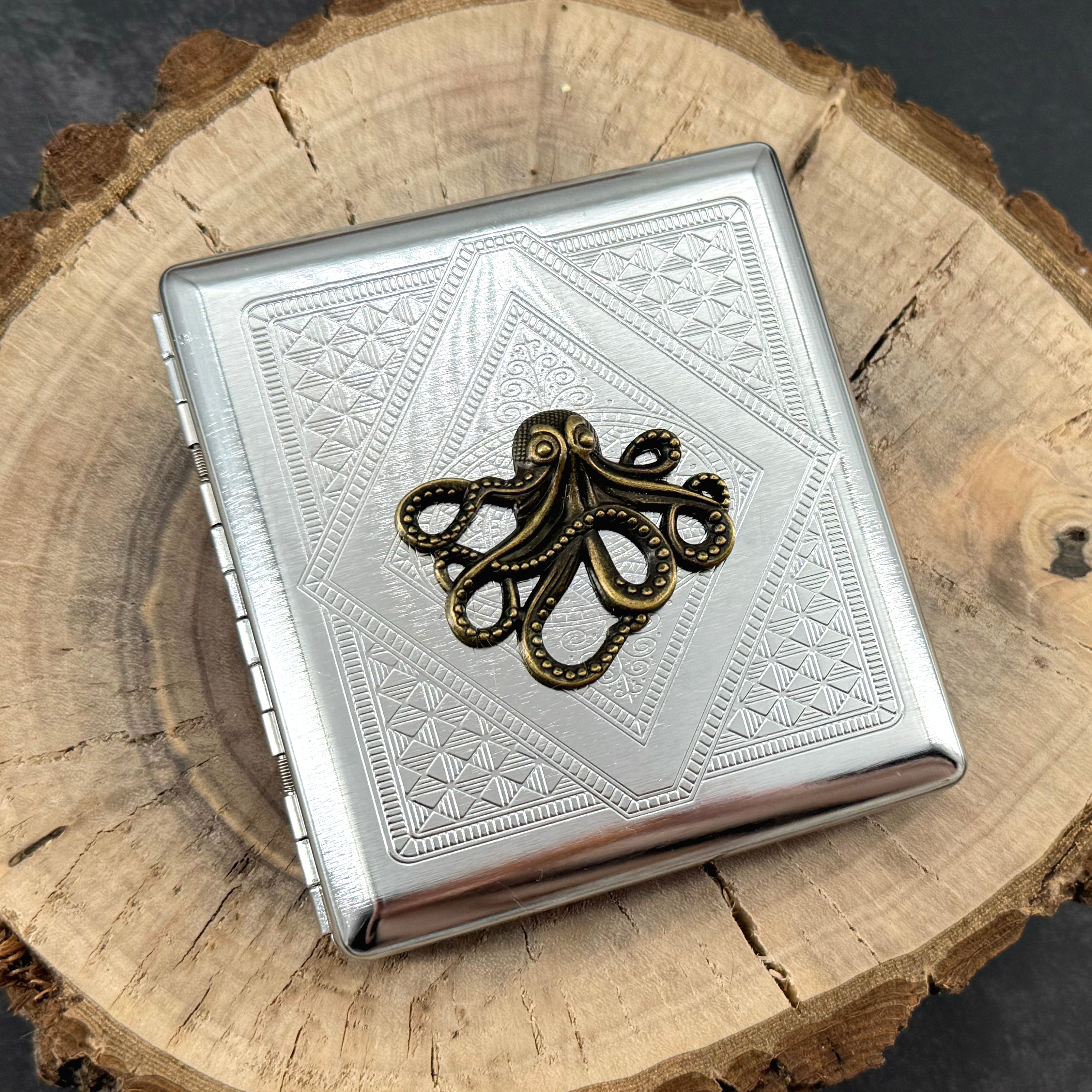 Handmade stamped metal octopus case featuring geometric pattern and bronze octopus centerpiece