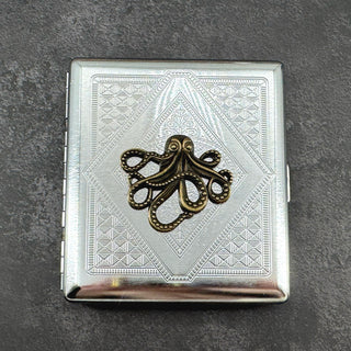 Ink and Tide octopus cigarette case with raised bronze octopus on silver stamped metal background