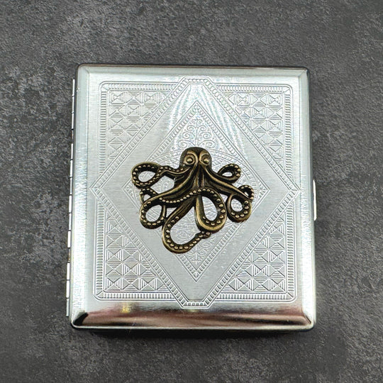 Ink and Tide octopus cigarette case with raised bronze octopus on silver stamped metal background