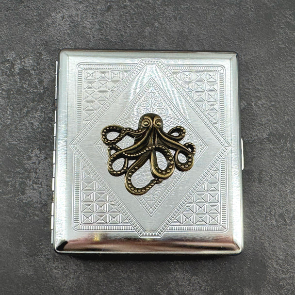 Ink and Tide octopus cigarette case with raised bronze octopus on silver stamped metal background