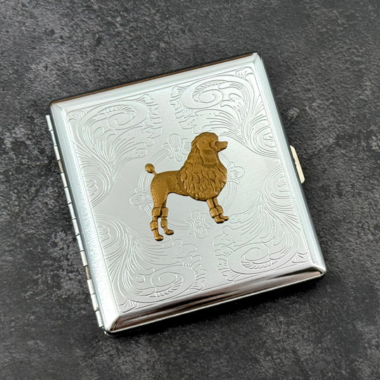Silver metal cigarette case with detailed bronze poodle centerpiece