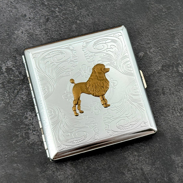 Silver metal cigarette case with detailed bronze poodle centerpiece
