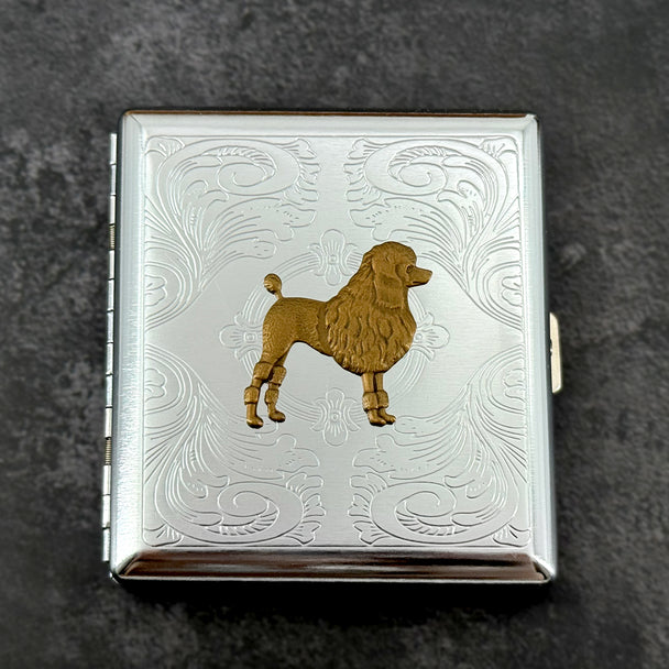 Bronze poodle metal cigarette case with silver stamped scrollwork background