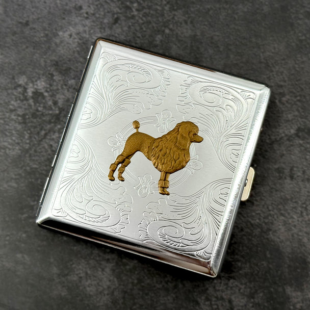 Handmade silver cigarette case featuring a raised bronze poodle