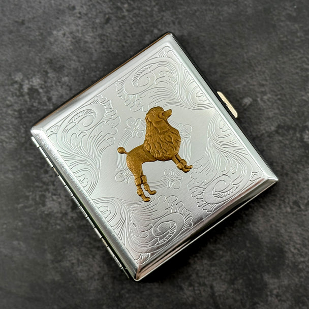Bronze poodle dog case with ornate stamped metal scrollwork