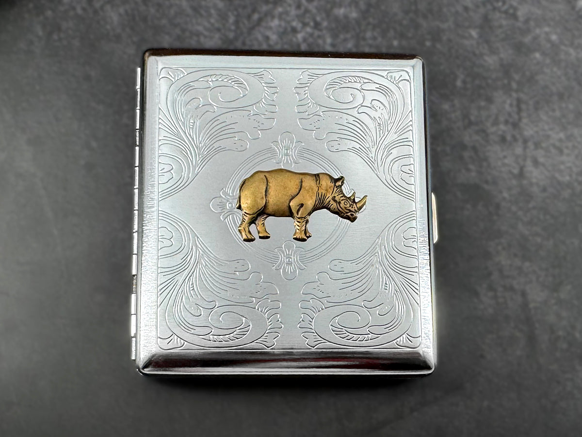 Handmade silver metal cigarette case featuring a raised bronze-toned rhinoceros.