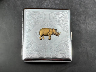 Handmade silver metal cigarette case featuring a raised bronze-toned rhinoceros.