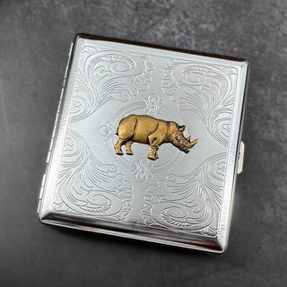 Angled view of handmade metal cigarette case featuring a bronze rhino.