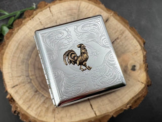Handmade silver metal cigarette case featuring a raised bronze-toned rooster centerpiece.