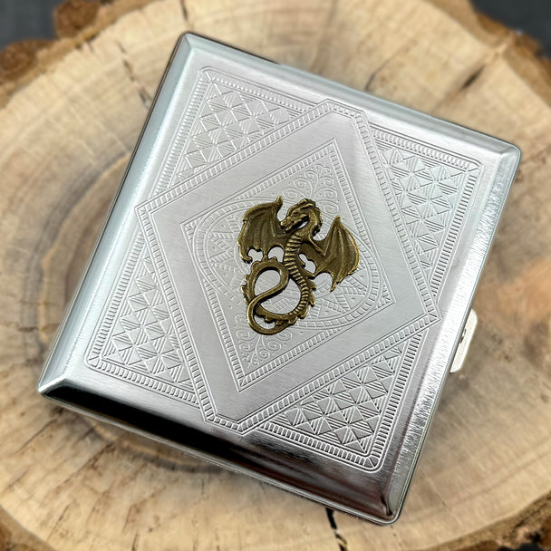Detailed bronze dragon with raised wings and curled tail on silver metal card holder