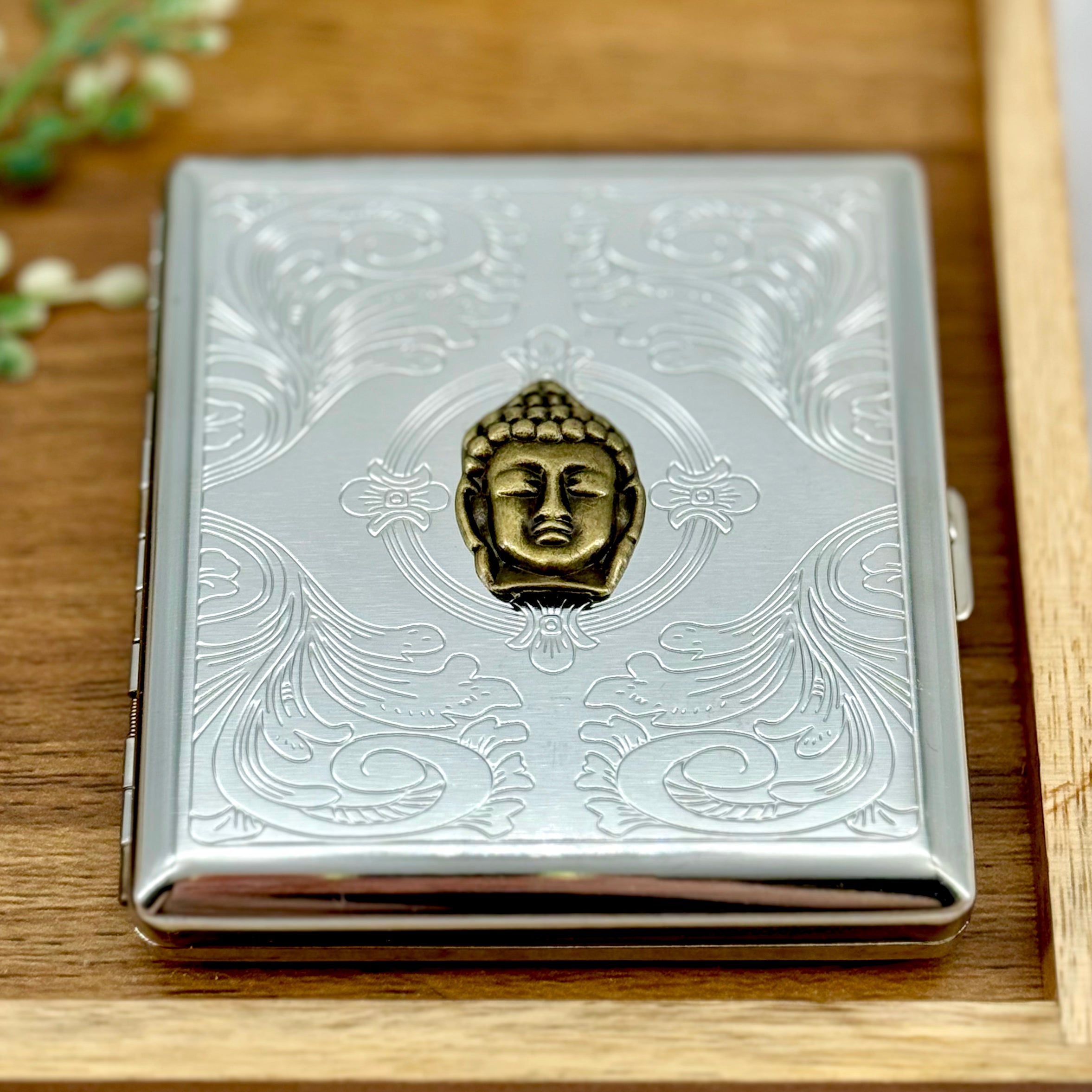 Buddha pocket case styled on a wooden tray with engraved silver finish