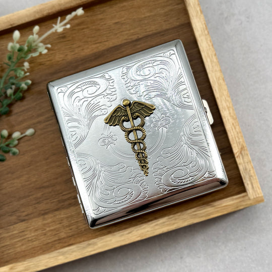 Handmade medical symbol case displayed on wooden tray with decorative engraving