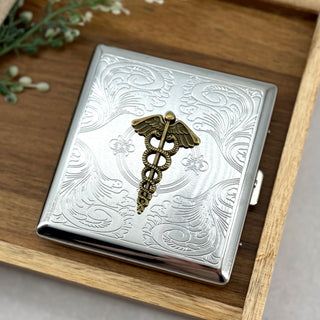 Caduceus pocket case with raised medical symbol and engraved silver scrollwork