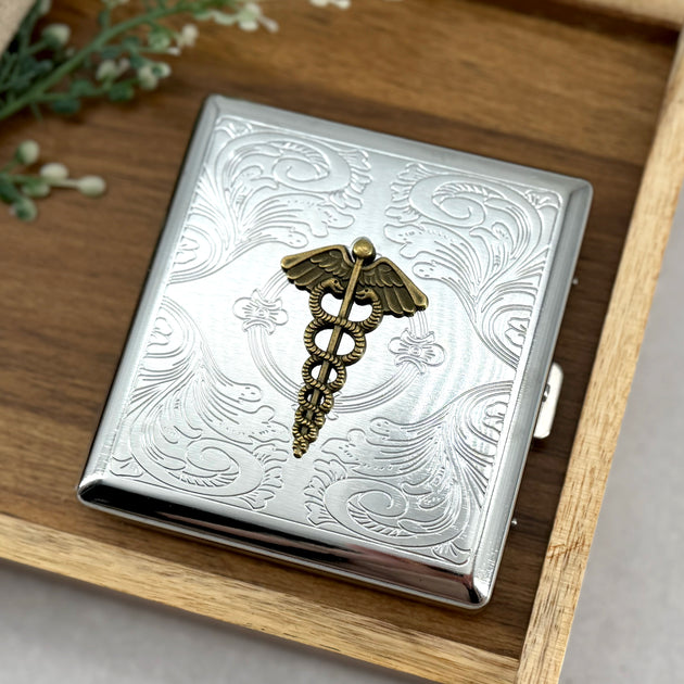 Caduceus pocket case with raised medical symbol and engraved silver scrollwork
