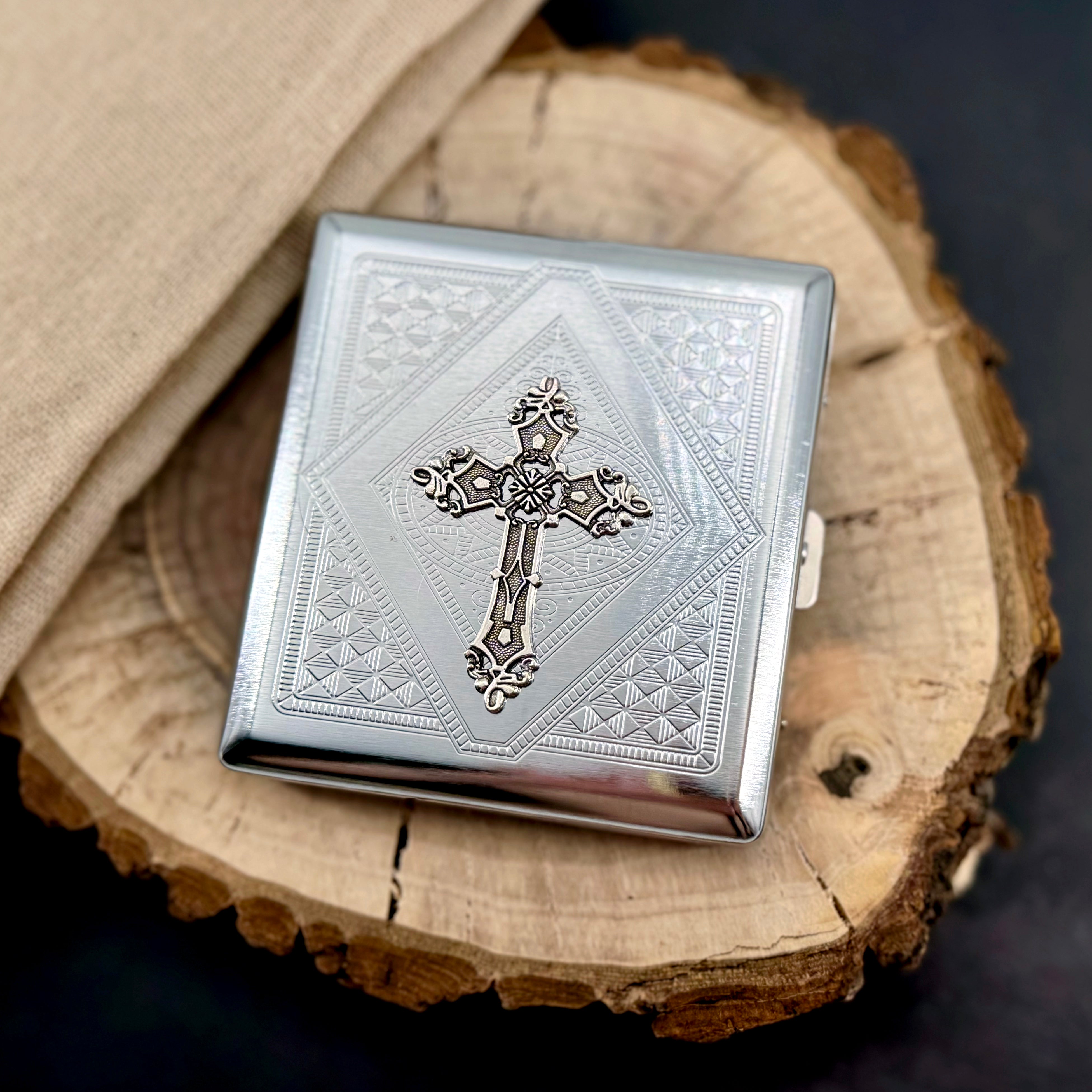 Cross pocket case displayed on natural wood with engraved silver finish