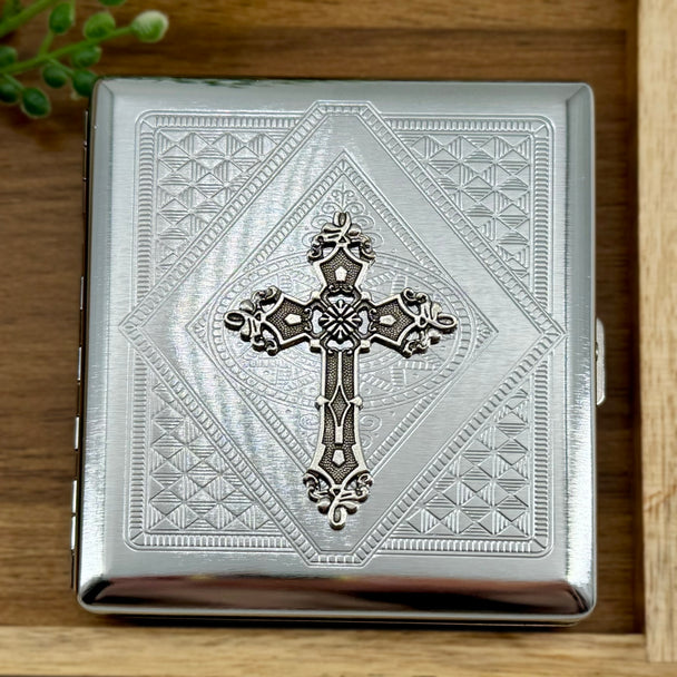Faith-inspired cigarette case with ornate raised cross and geometric detailing