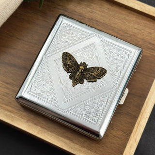 Death’s-head hawkmoth cigarette case with a bronze-toned moth and geometric stamped background