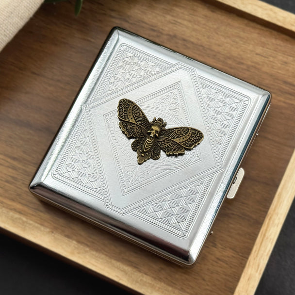 Death’s-head hawkmoth cigarette case with a bronze-toned moth and geometric stamped background