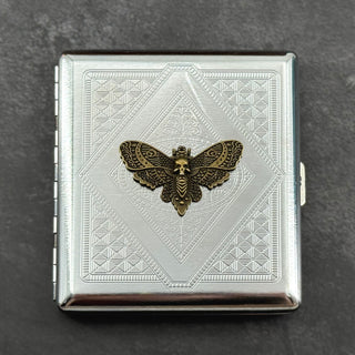 Silver-toned gothic card holder featuring a raised skull moth on an angular geometric pattern