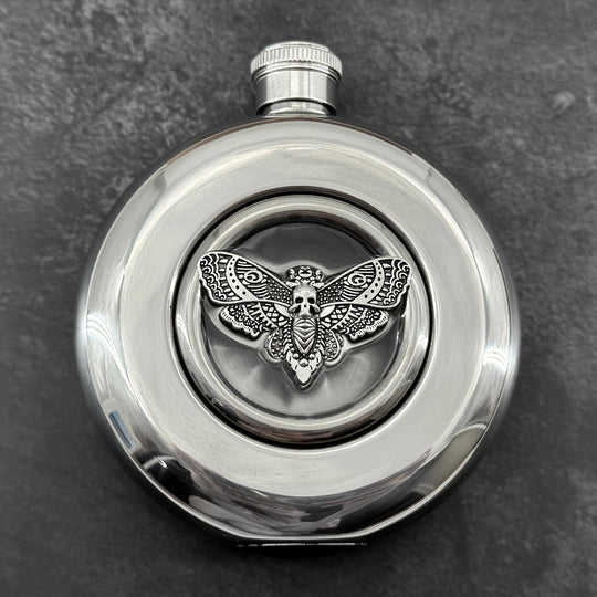 Mirror-finish 5 oz hip flask featuring a resin-embedded skull moth centerpiece
