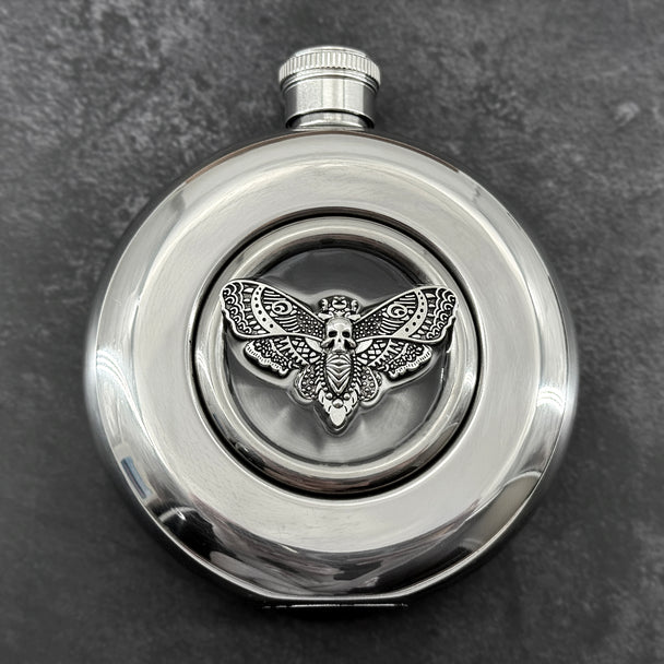 Mirror-finish 5 oz hip flask featuring a resin-embedded skull moth centerpiece