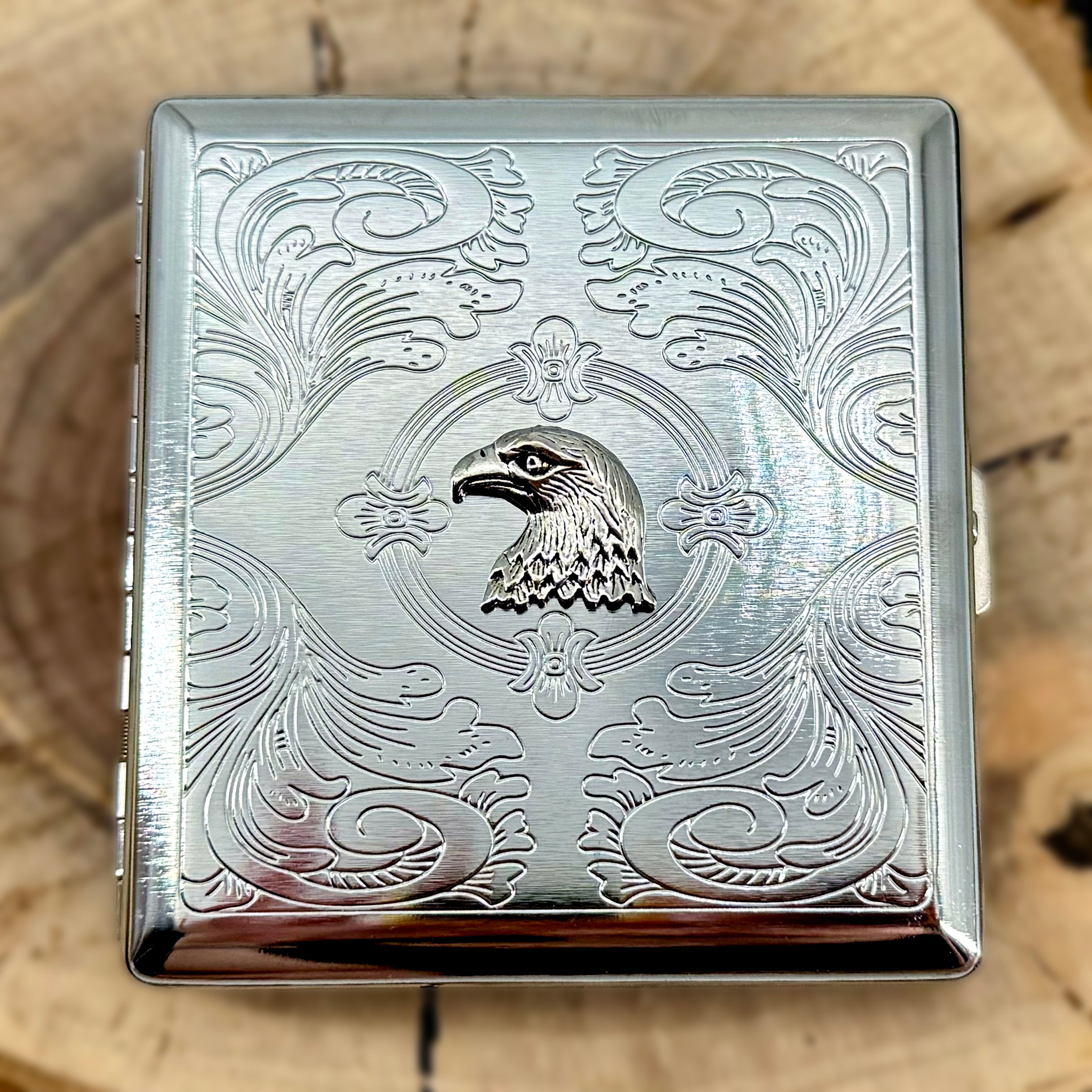 Eagle cigarette case featuring raised eagle design on engraved silver metal case
