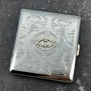 Silver-tone cigarette case with protective evil eye embellishment and secure closure