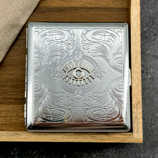 Handmade metal cigarette case featuring a raised evil eye symbol and ornate detailing
