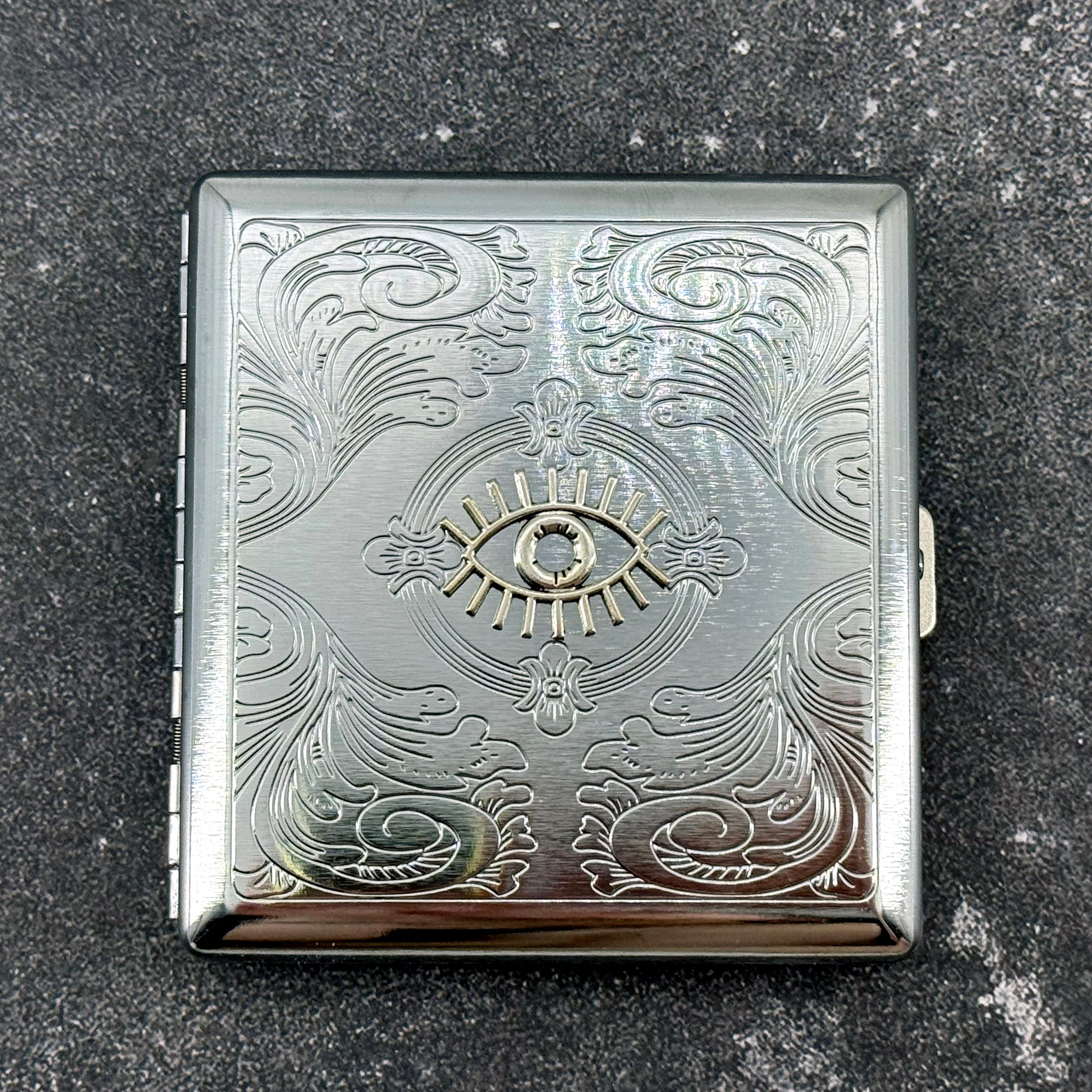 Mystical evil eye card holder with decorative engraved floral scroll design