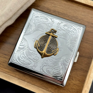 Stamped metal cigarette case with raised anchor and rope design