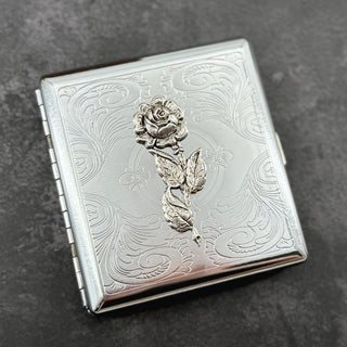 Elegant rose case with decorative botanical design and secure snap closure.