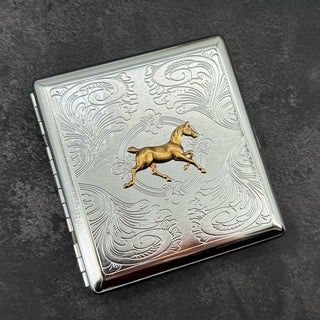 Horse cigarette case displayed in styled setting showing compact pocket size