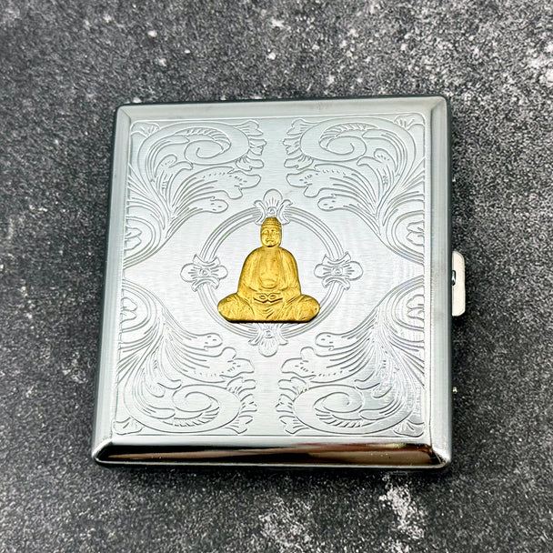 Decorative Buddha cigarette case with raised golden Buddha and engraved ornamental detailing