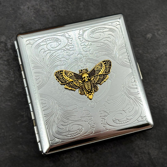 Victorian-inspired skull moth pocket case with intricate stamped metal background