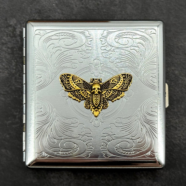 Gothic metal card case with raised golden Death's-head hawkmoth and decorative scrollwork
