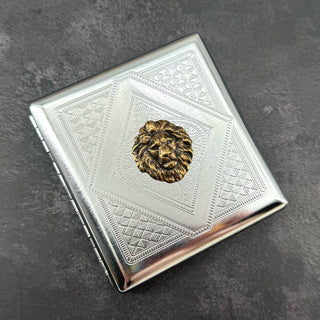 Lion cigarette case closed front view with polished silver finish and snap closure