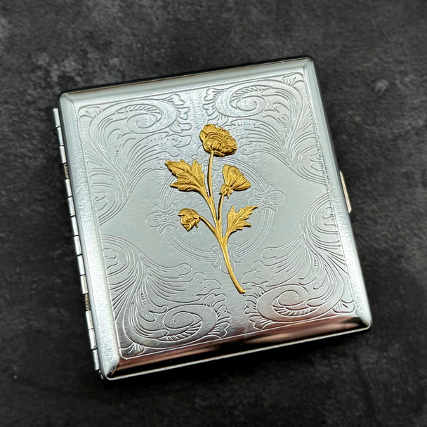 Ornate silver business card holder with raised wildflower decoration.