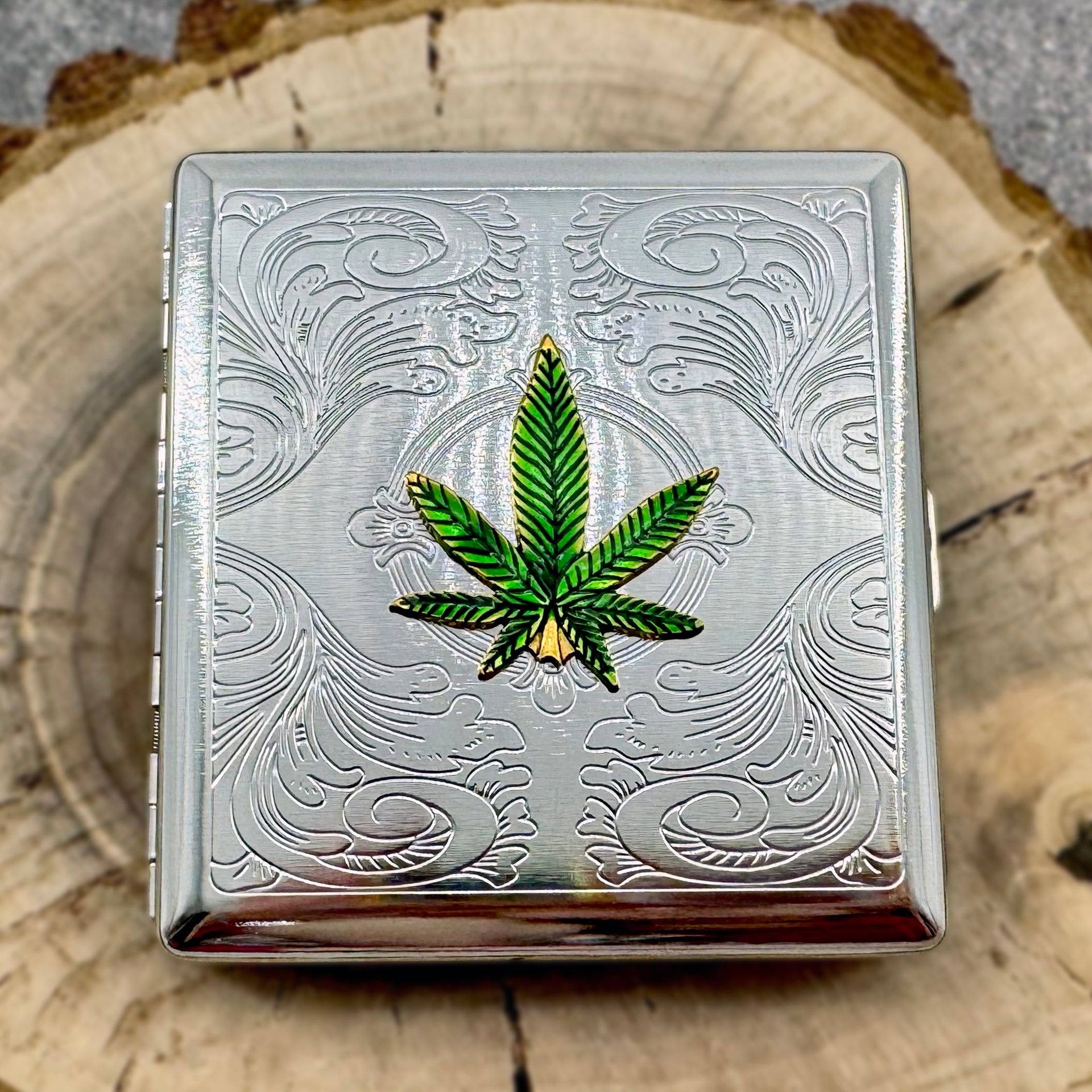 High Society Case Emerald Edition featuring green cannabis leaf and engraved scrollwork