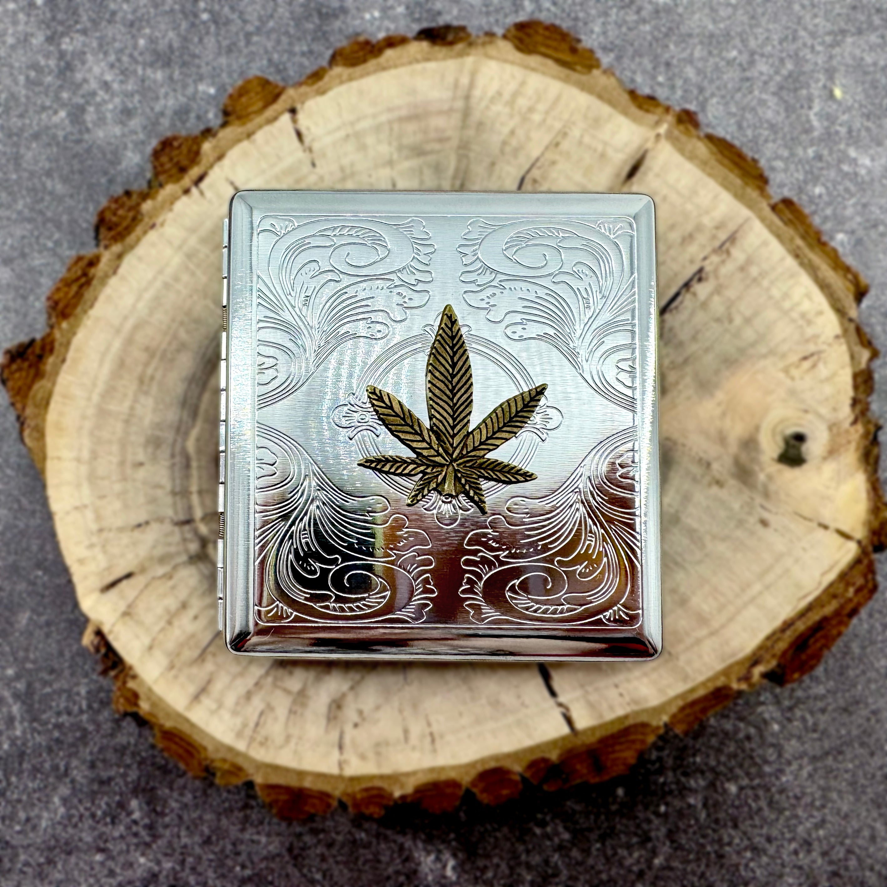 Cannabis card holder with polished metal finish and leaf emblem