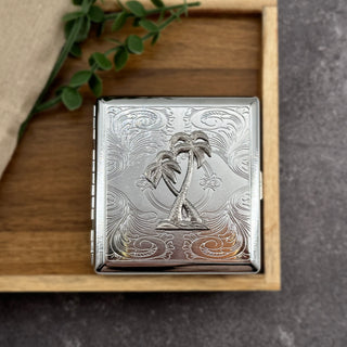 Palm Paradise cigarette case featuring raised palm tree design on engraved silver metal case