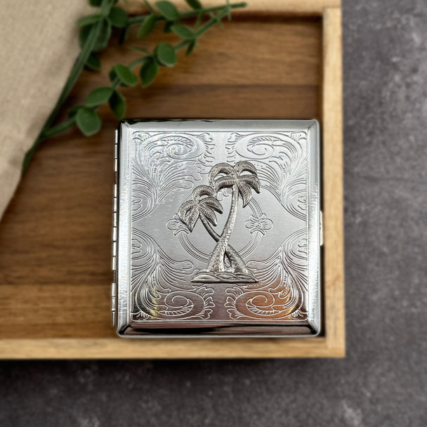 Palm Paradise cigarette case featuring raised palm tree design on engraved silver metal case