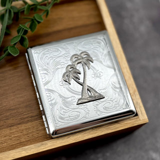 Handmade palm tree cigarette case with tropical island motif and ornate scrollwork detailing