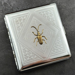 Victorian-inspired beetle pocket case featuring an ornate geometric stamped pattern